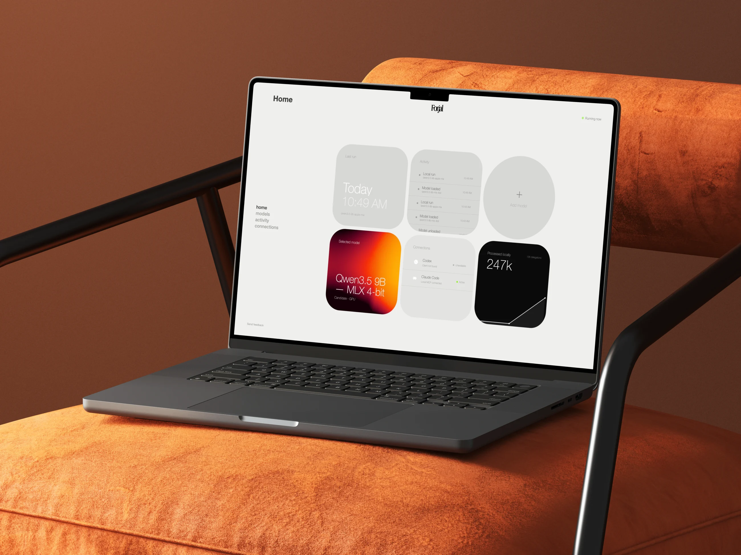 Forjal running on a MacBook placed on an orange armchair